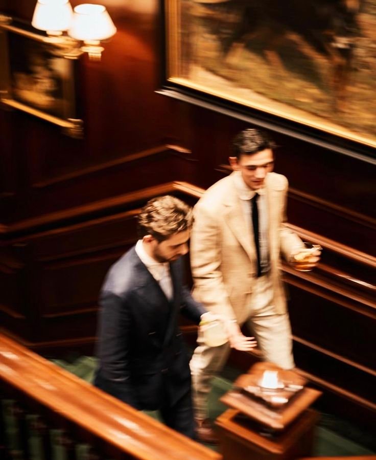 Two men ascending an elegant staircase