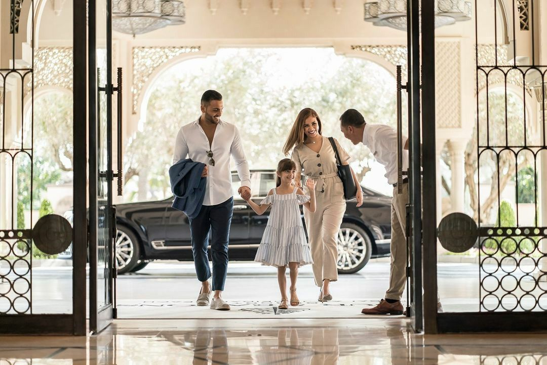 A family arriving at a grand hotel